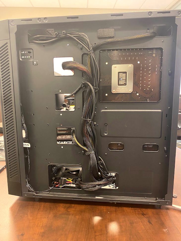 Back of a PC case showing neatly tied cable management