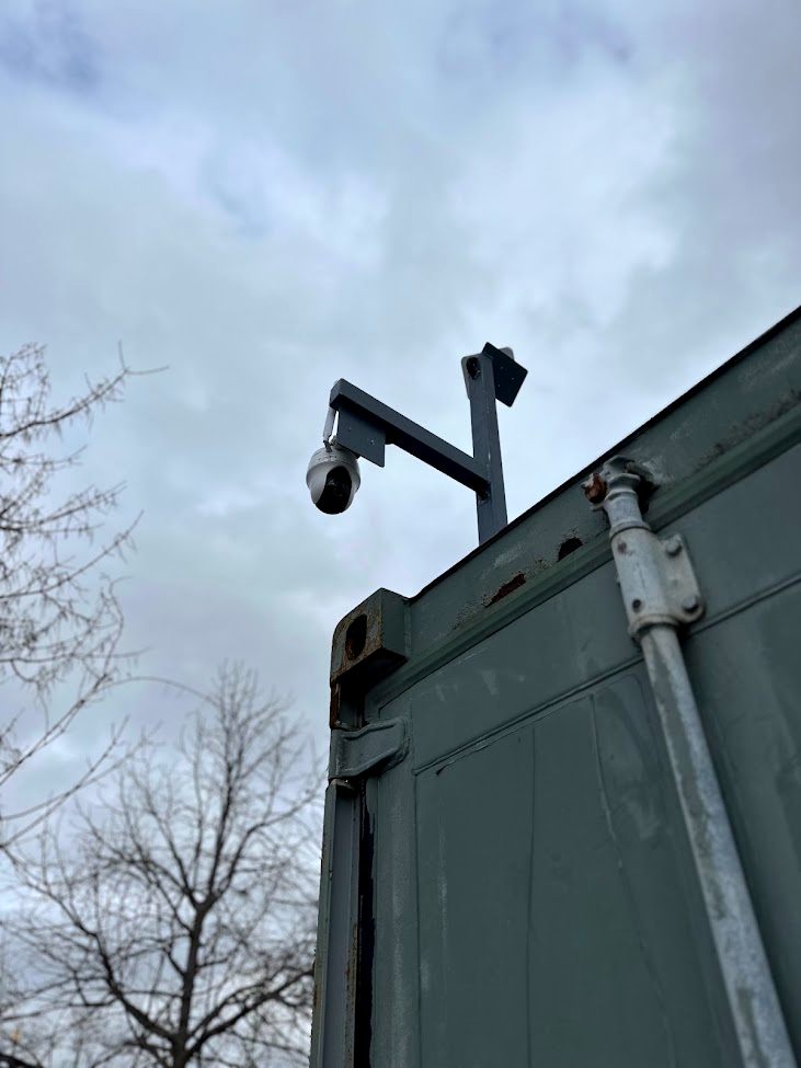 Reolink PTZ camera on a custom steel mount above a storage container